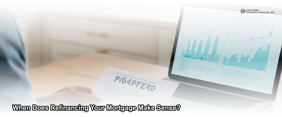 Newark Delaware homeowner reviewing mortgage refinance documents at a kitchen table with a laptop open to financial charts