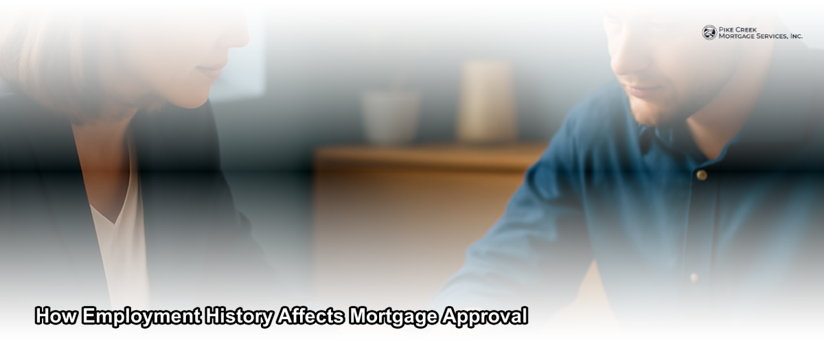 A mortgage loan officer reviewing an applicant's employment documents at a desk in a professional office setting