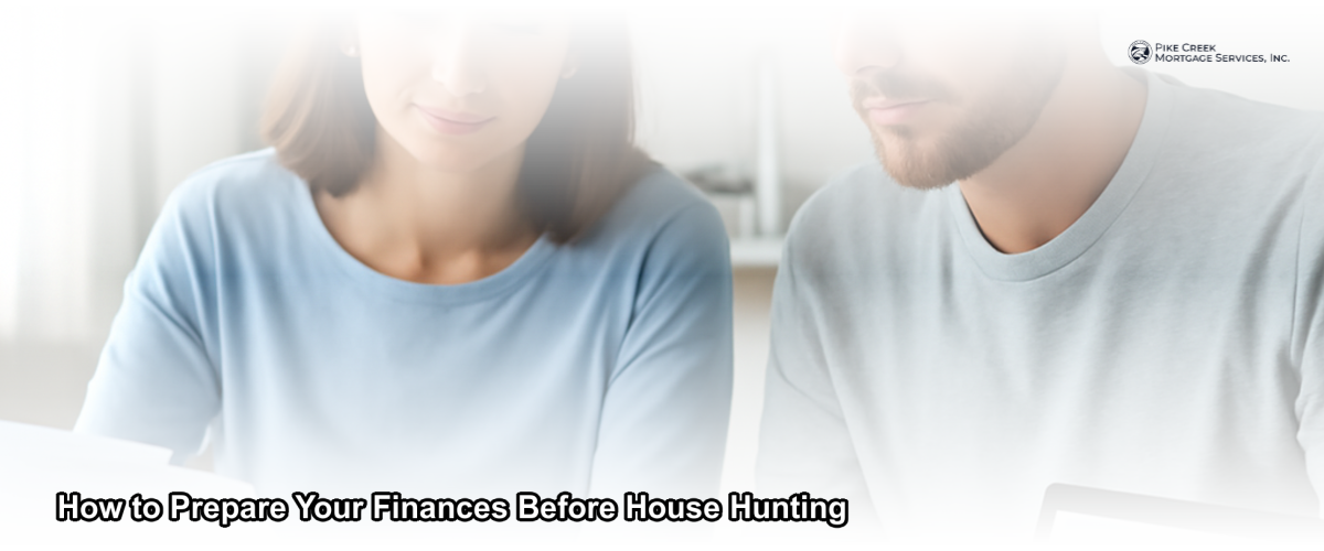 A couple reviewing financial documents at a kitchen table before starting their home search in Newark, Delaware