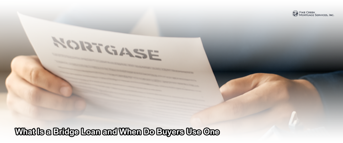 A homeowner reviewing bridge loan documents at a desk with a new house key and a for-sale sign visible in the background
