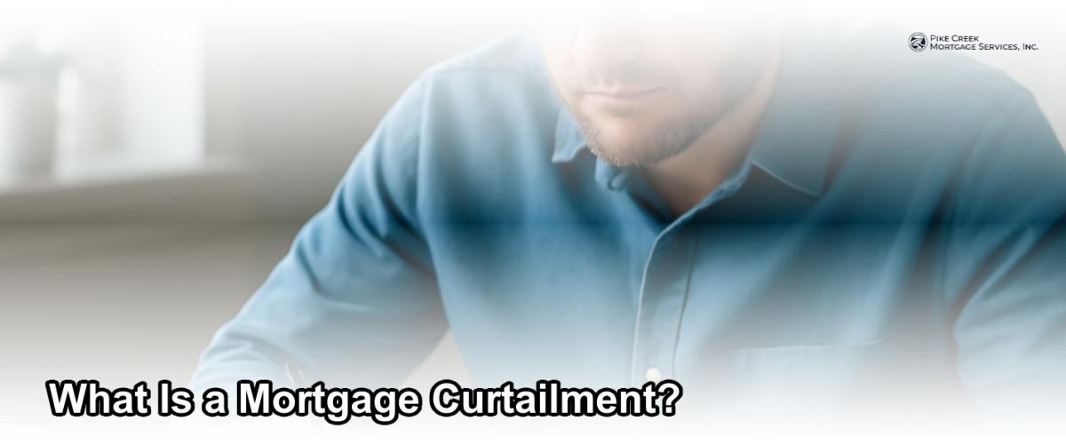 Homeowner reviewing mortgage documents and making an extra principal payment at a desk in a bright home office