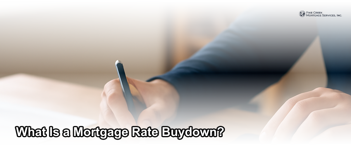 A homeowner reviewing mortgage documents at a desk with a calculator, representing the decision to buy down a mortgage rate in Newark Delaware.
